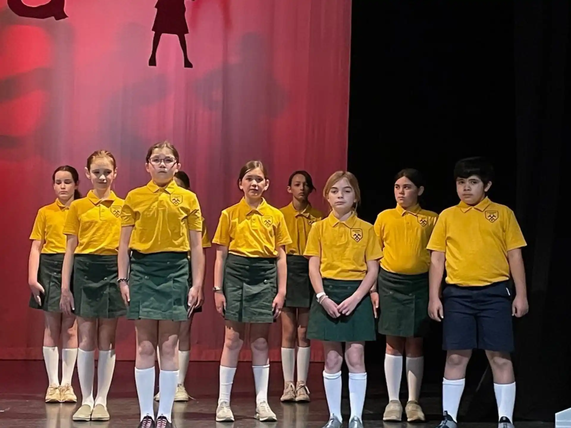 a group of people wearing matching yellow shirts