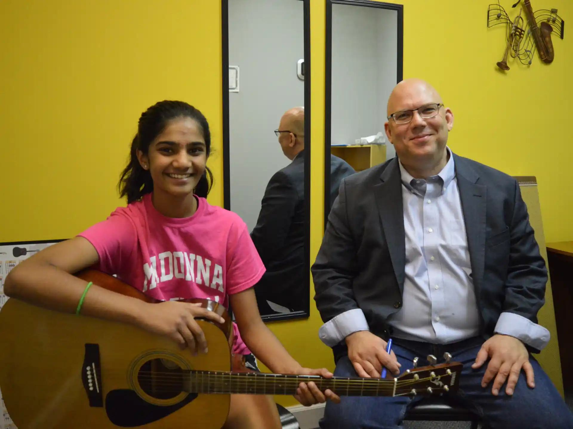 a man and a woman holding a guitar