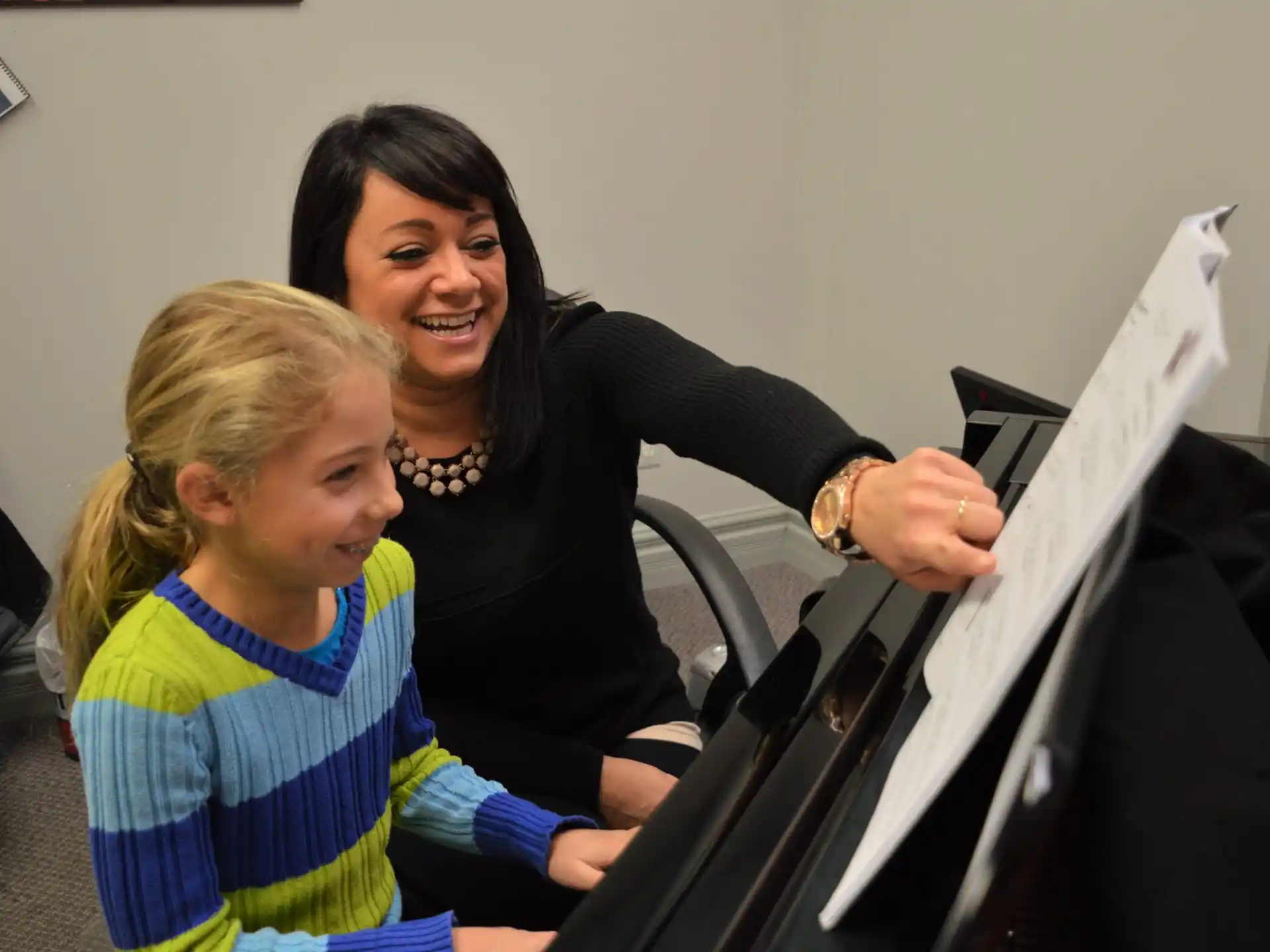a person and a child looking at a computer