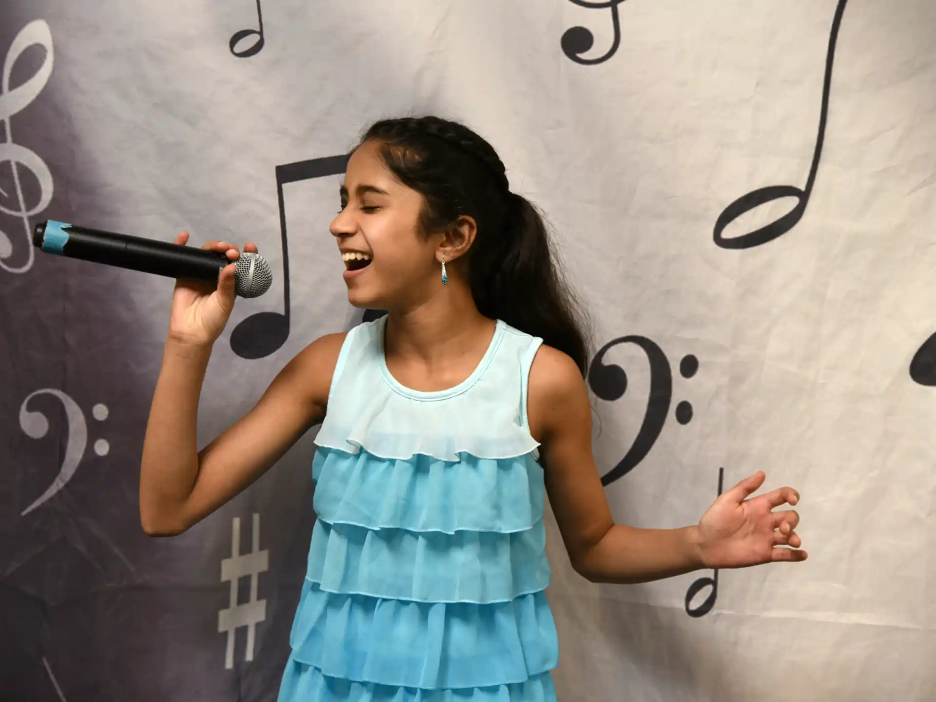 a person singing into a microphone