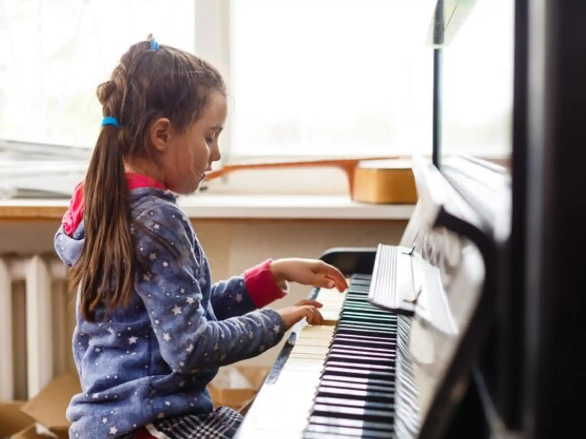 a girl playing a piano