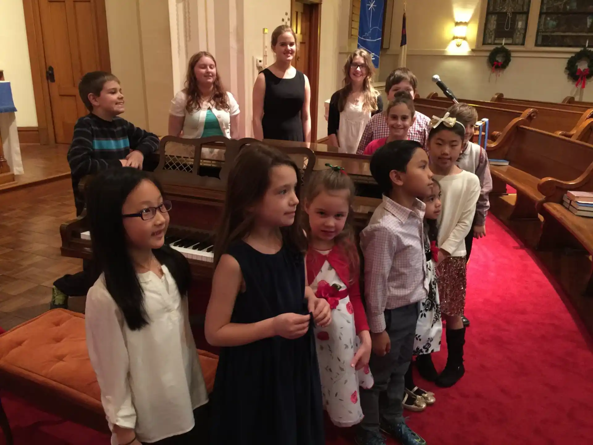a group of people standing in a room with a person and a child