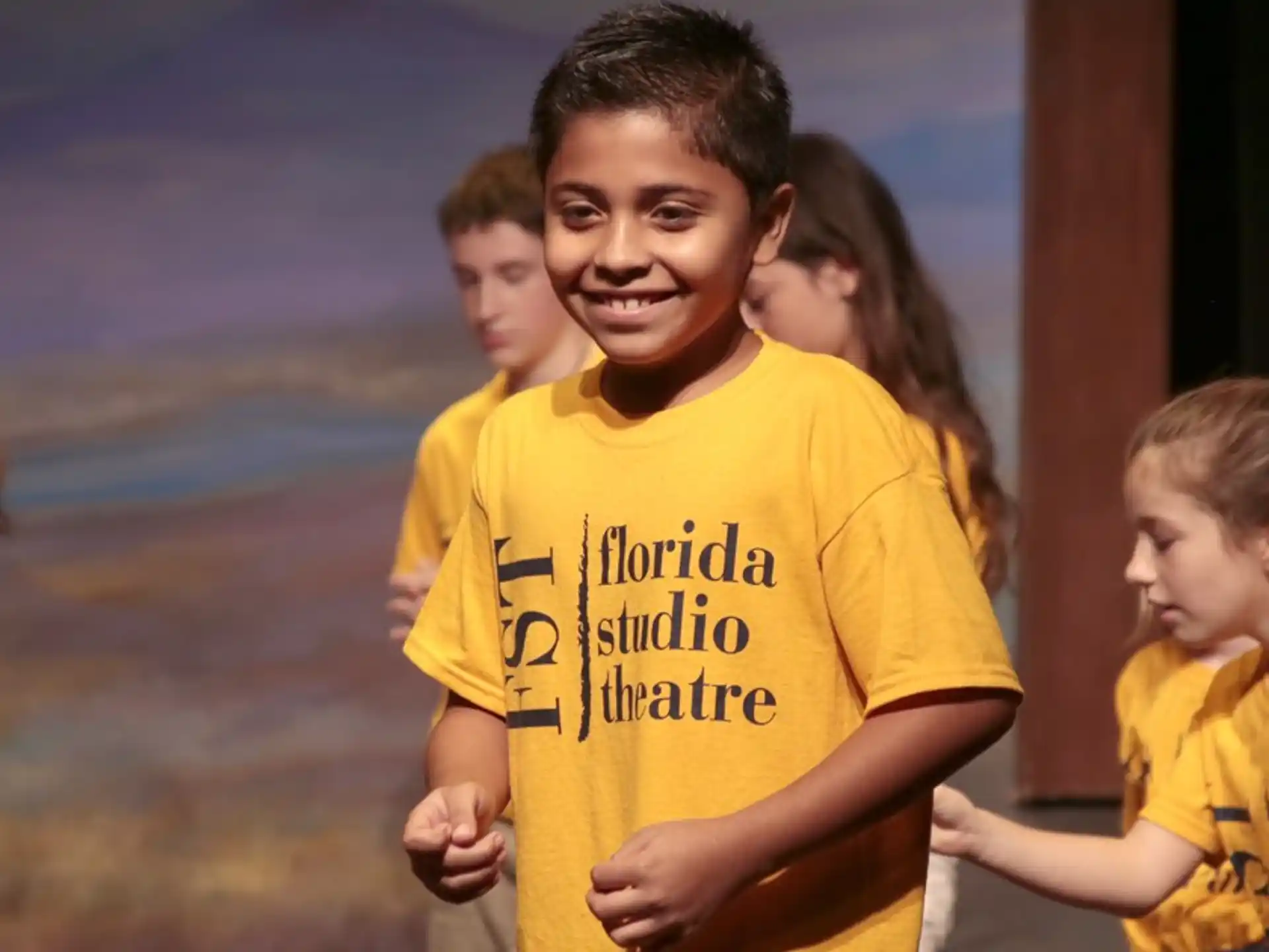 a group of children in yellow shirts