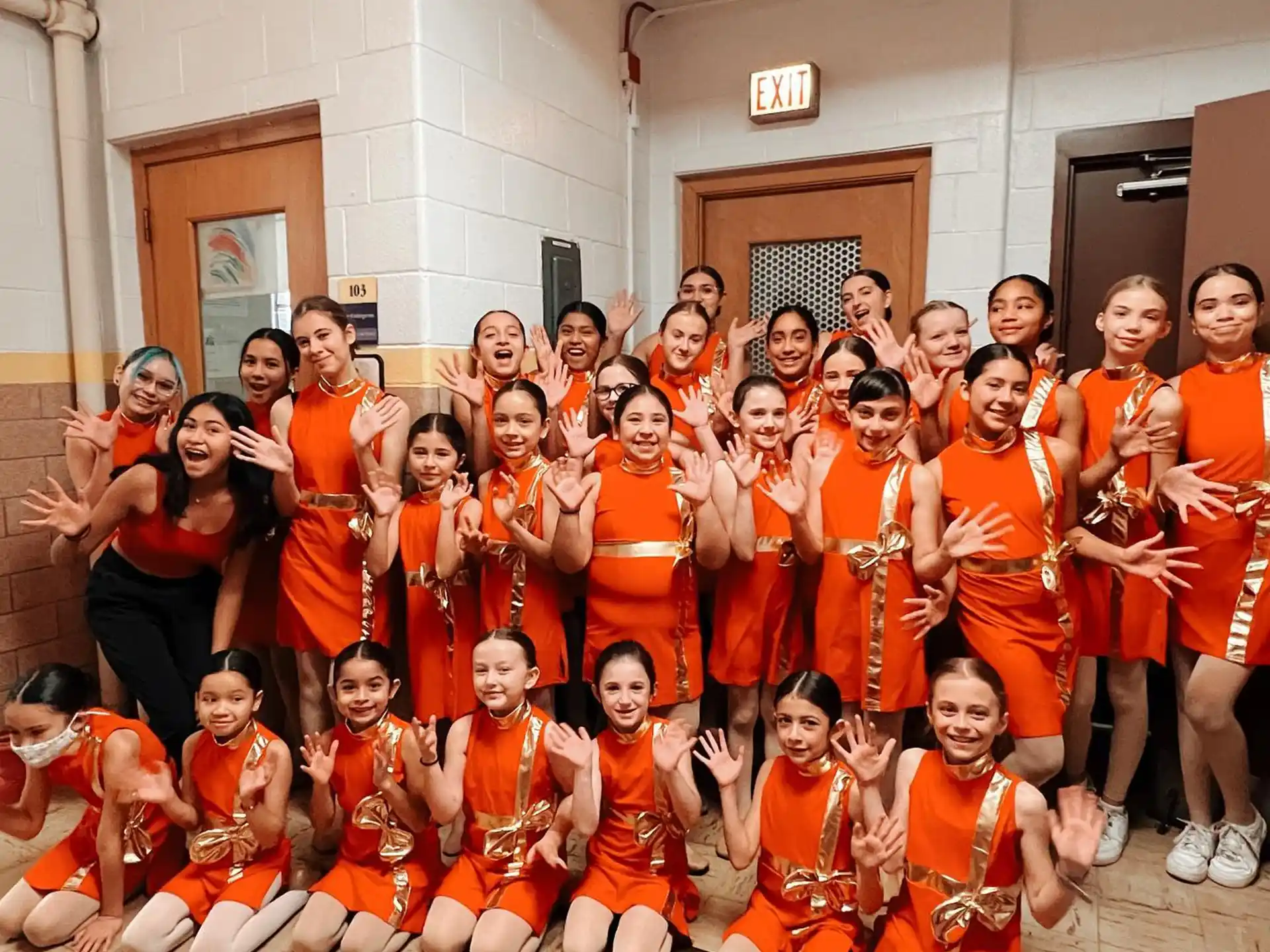 a group of people in orange uniforms