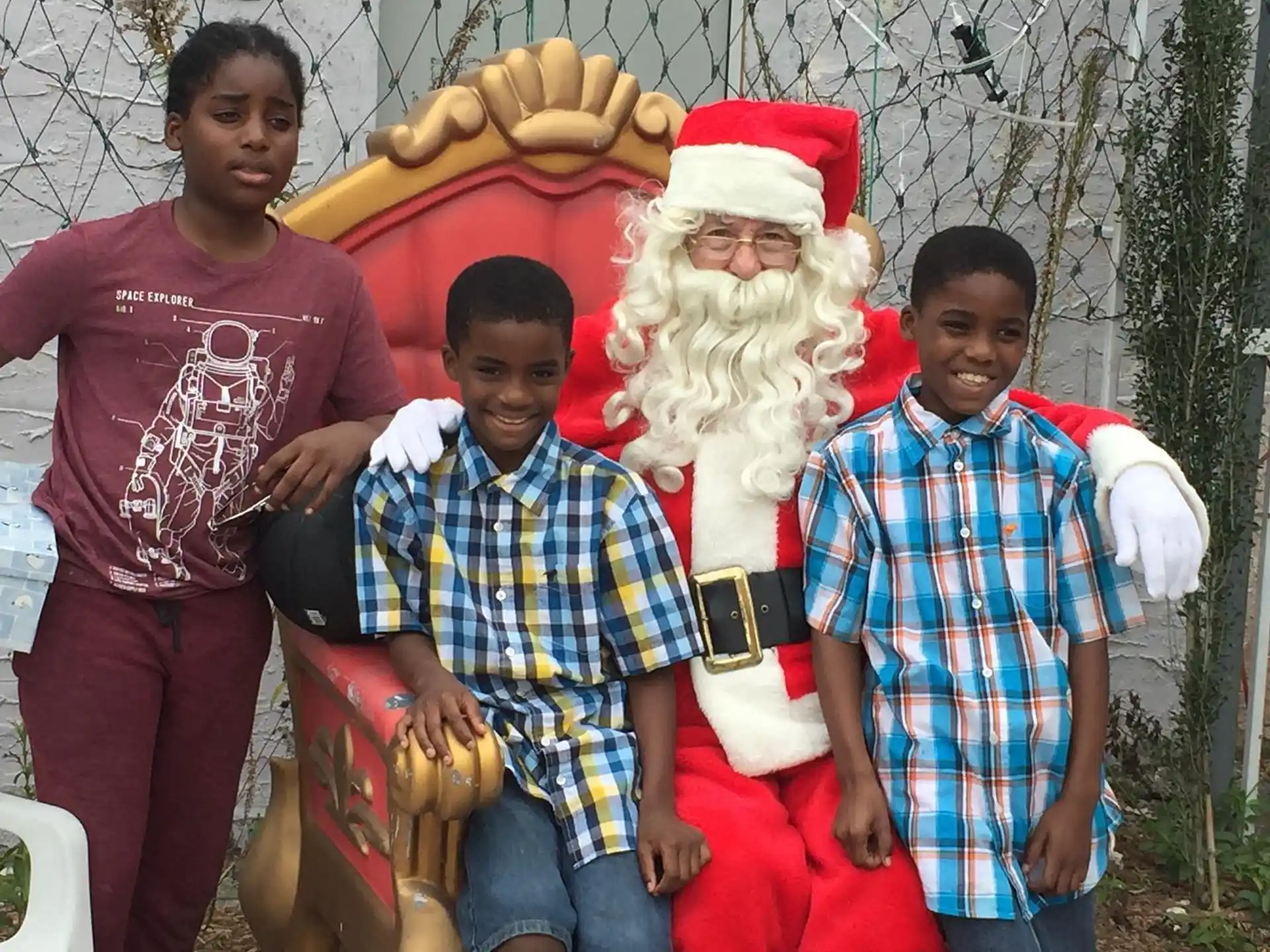 a group of people posing with a santa claus