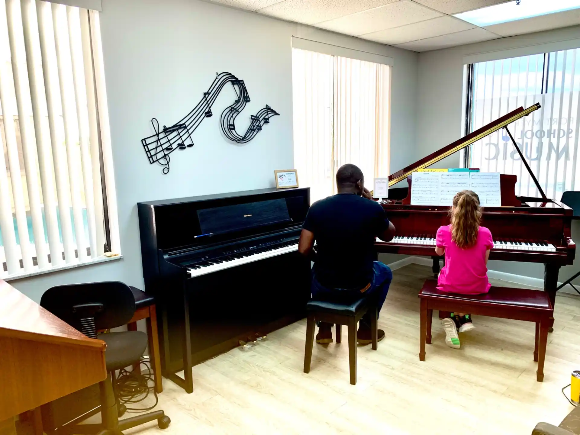 a man and a woman playing piano