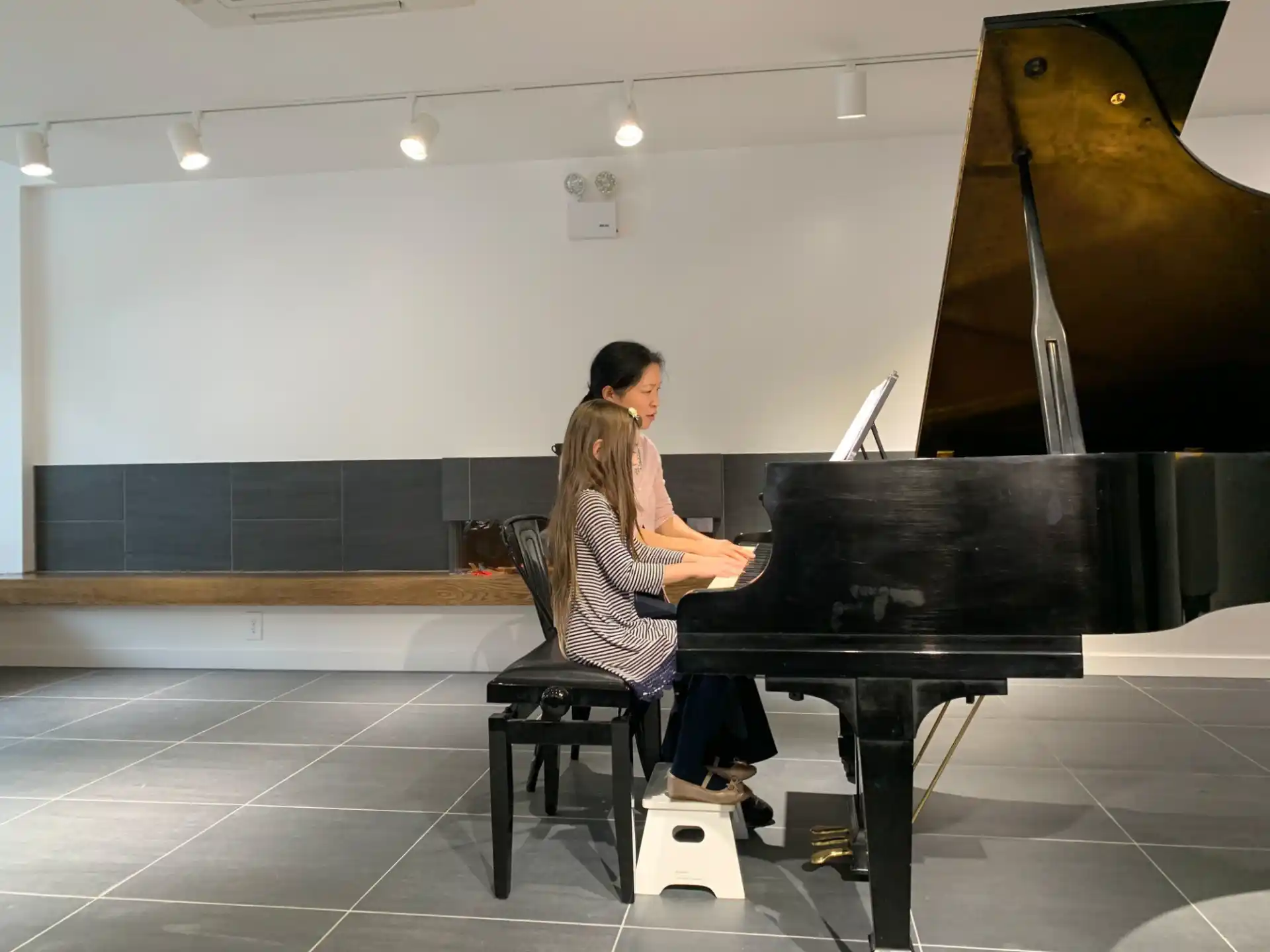 a man and woman playing piano