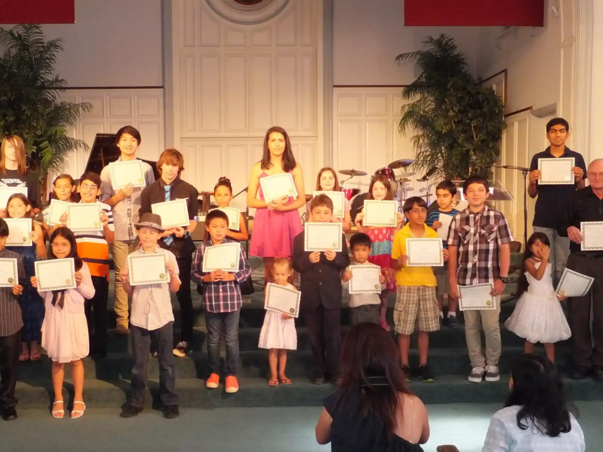 a group of people holding certificates