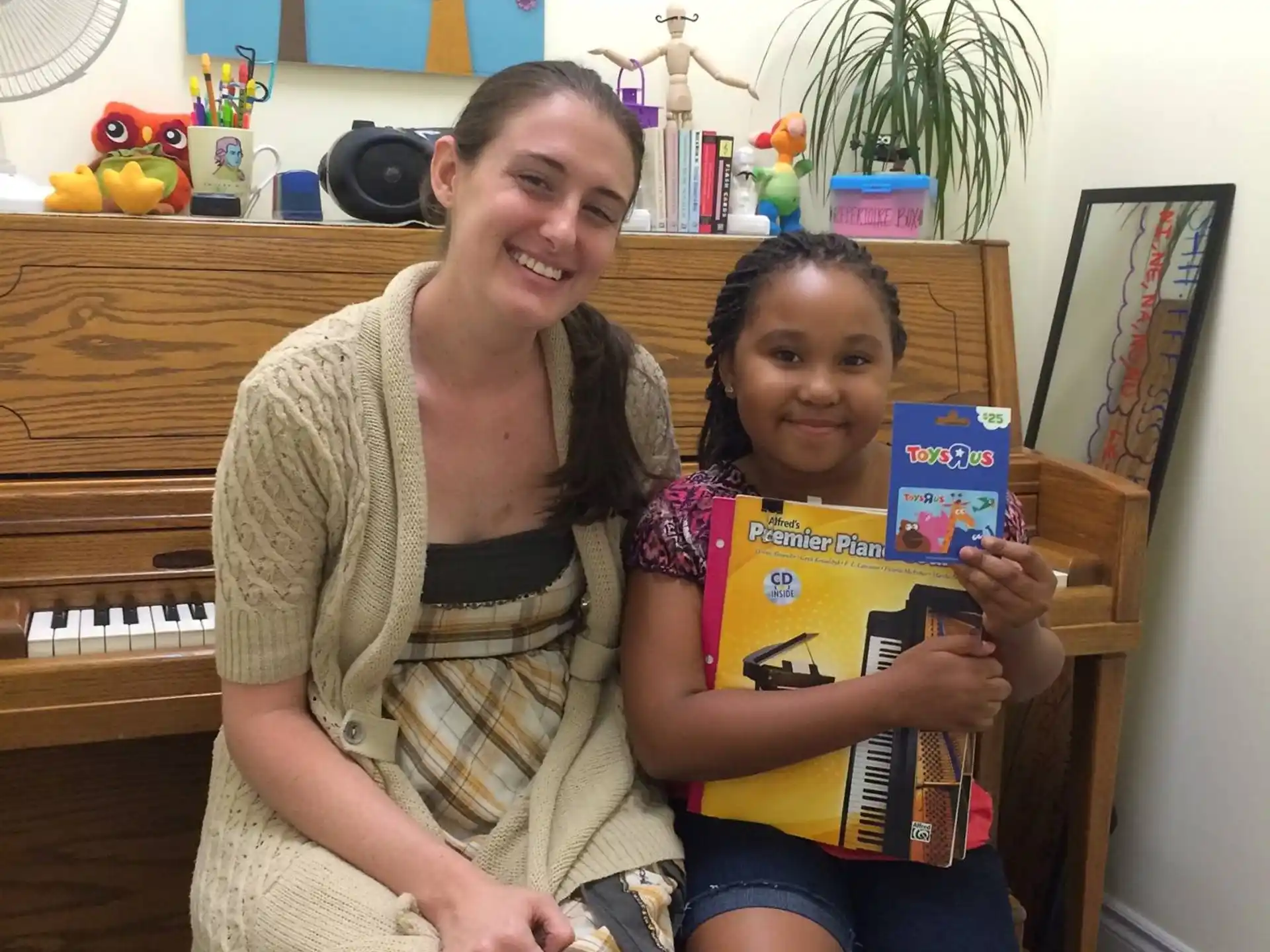 a woman and a child holding books