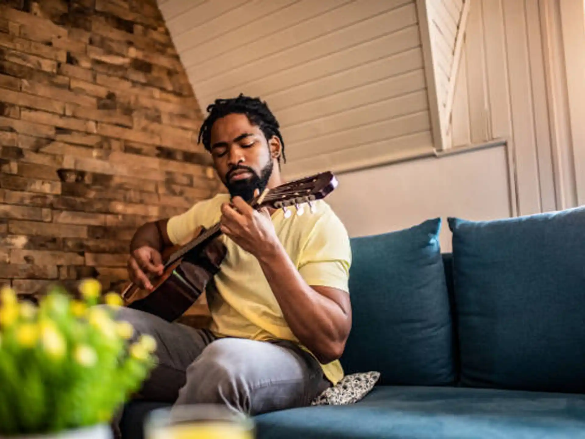 a man sitting on a couch reading a book