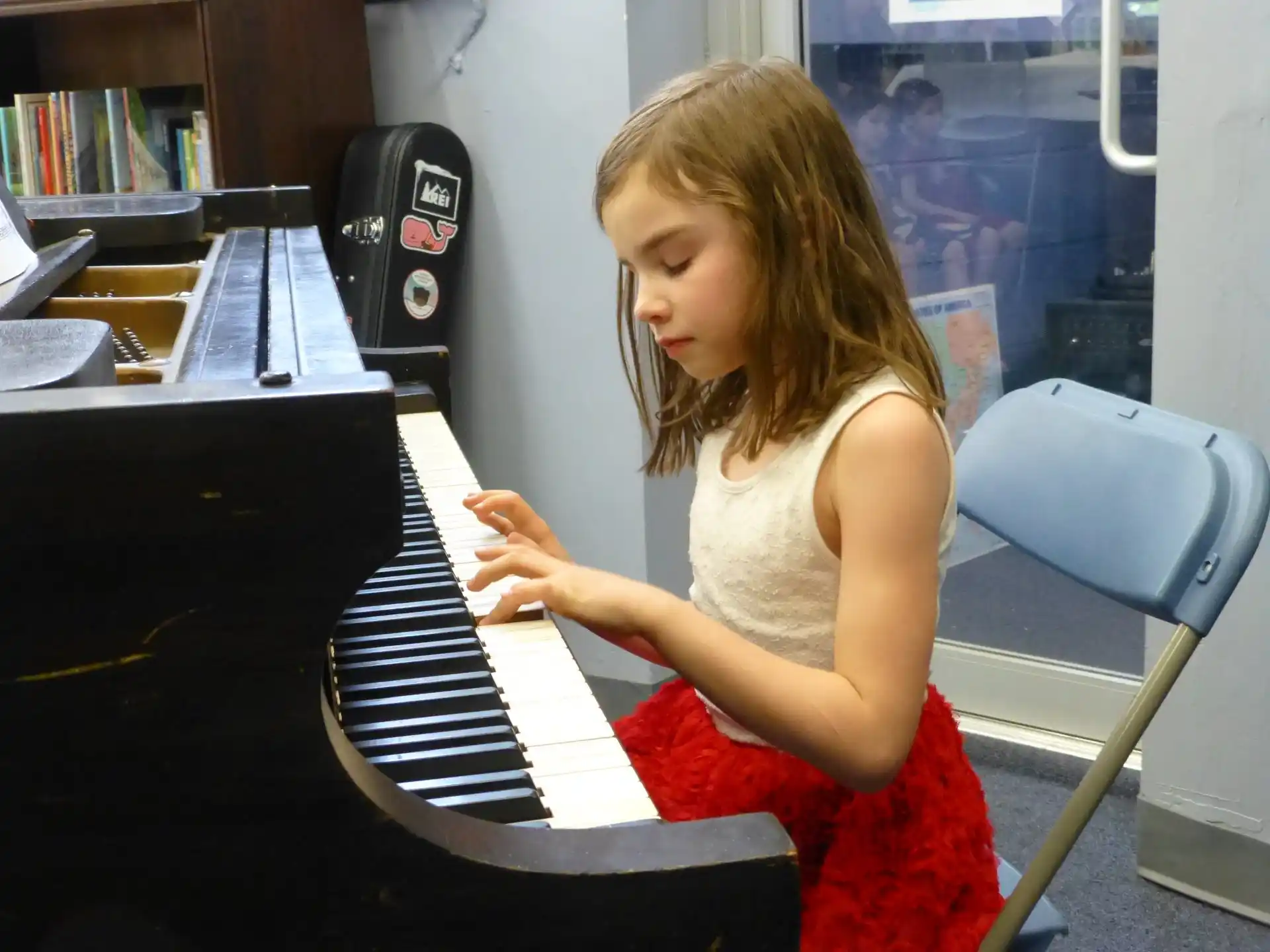a girl playing a piano