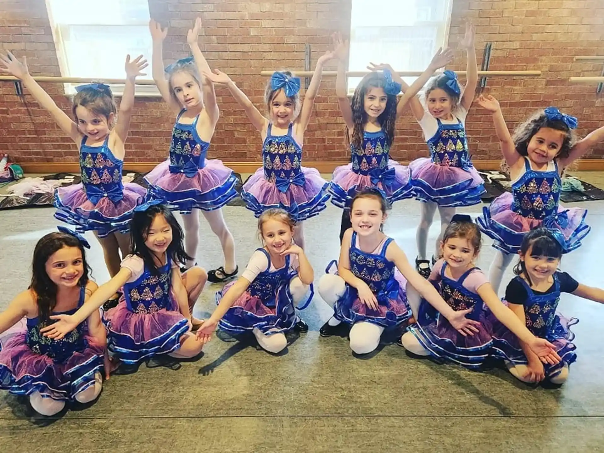 a group of girls in matching outfits