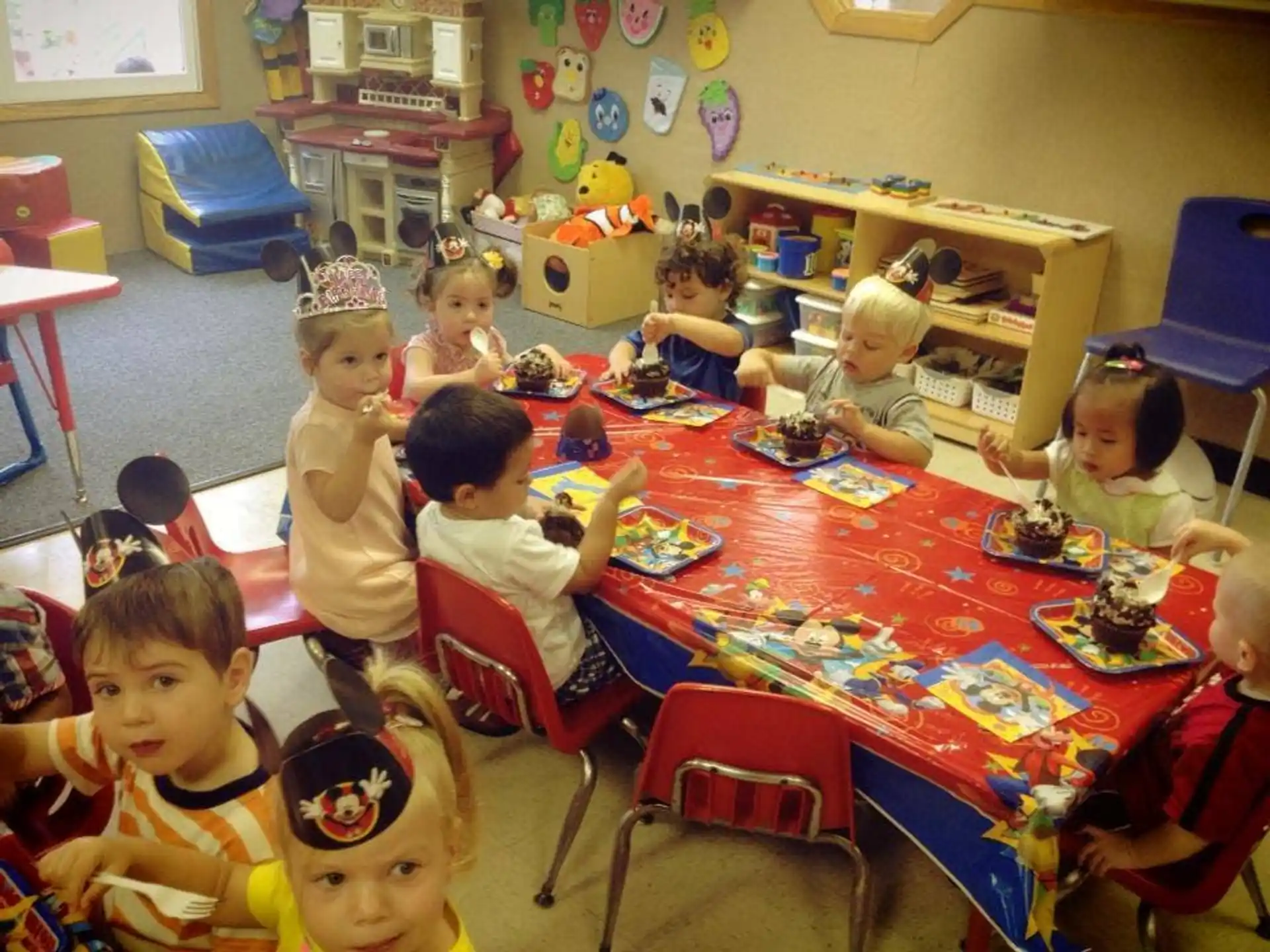 a group of children sitting around a table