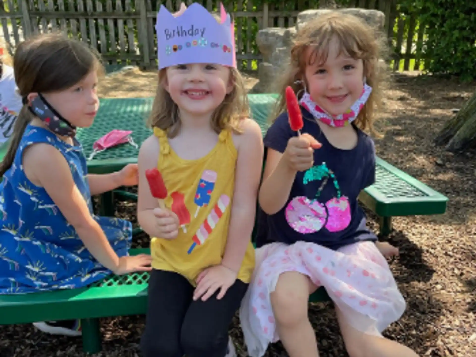 a group of children sitting on a bench