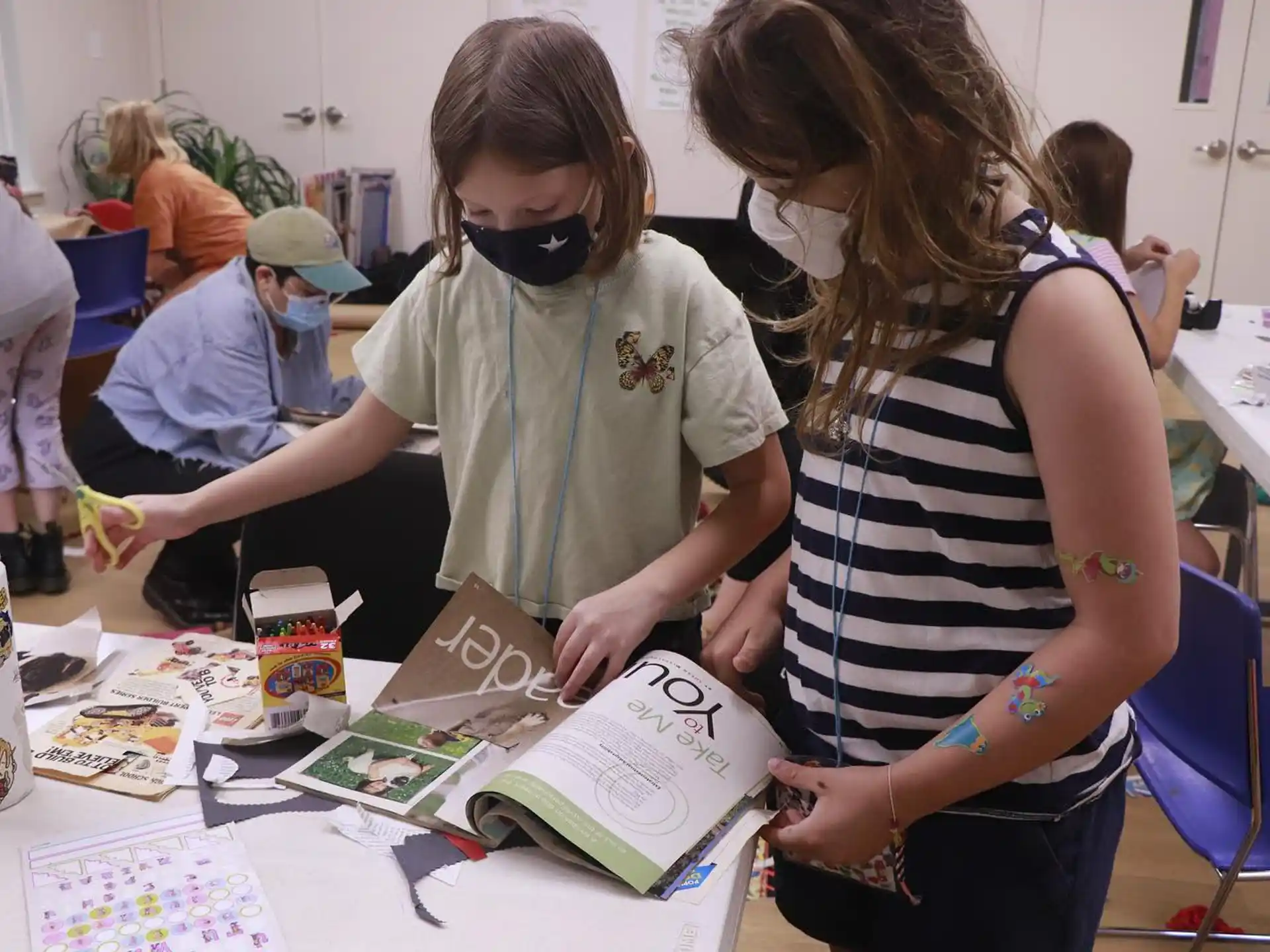 a person showing a girl something on a book