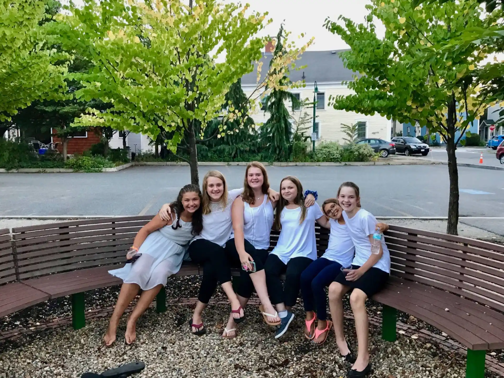 a group of women sitting on a bench
