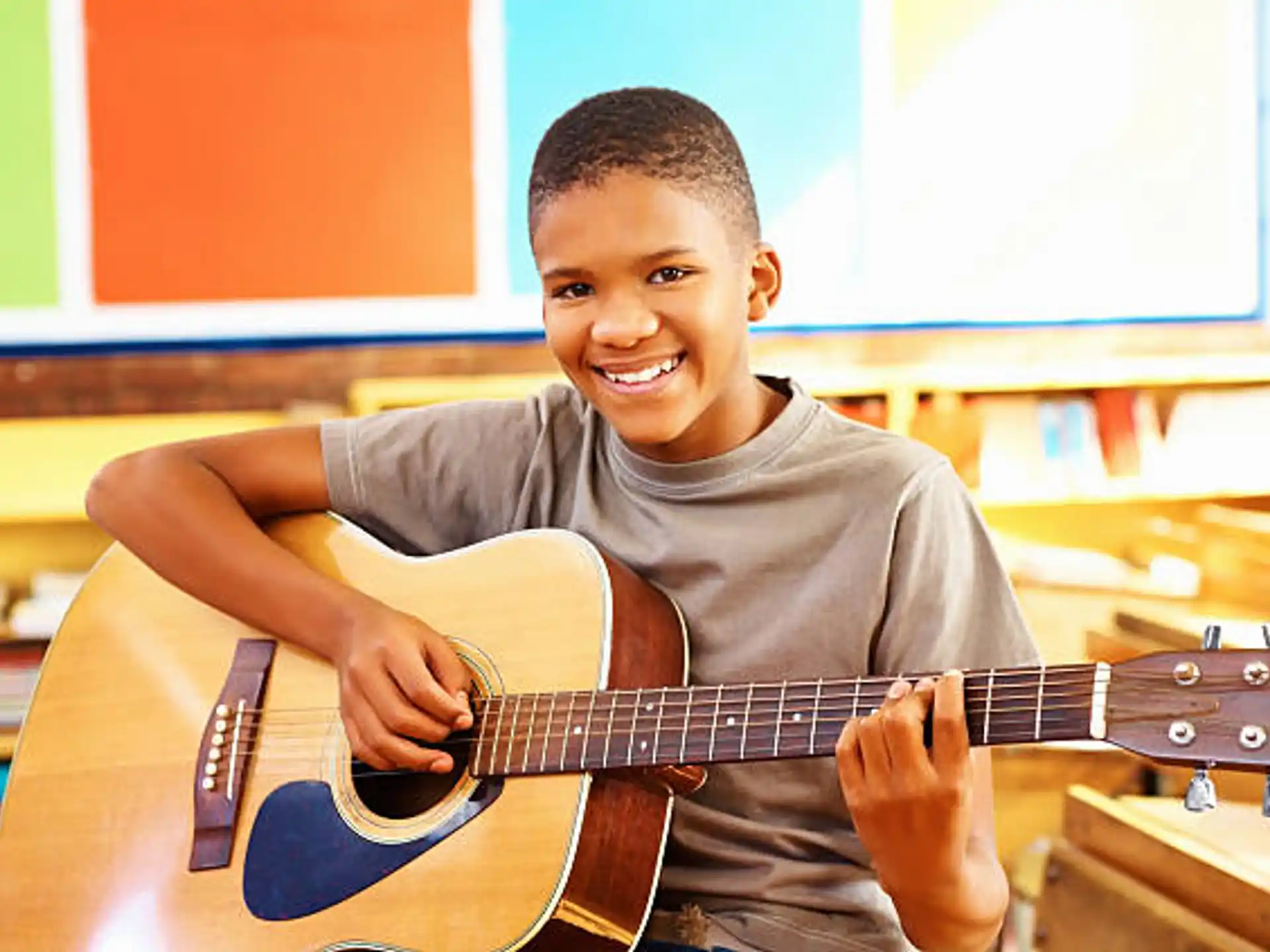 a boy playing a guitar
