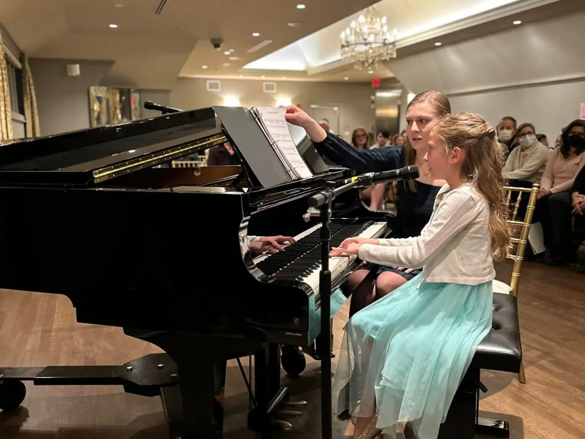 a man and woman playing piano