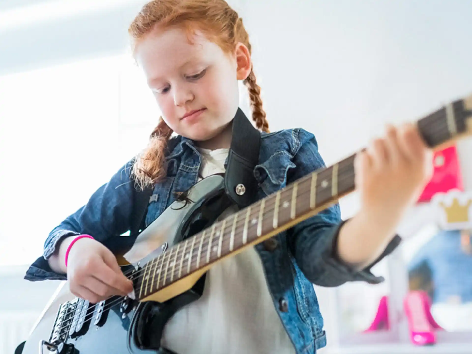 a girl playing a guitar
