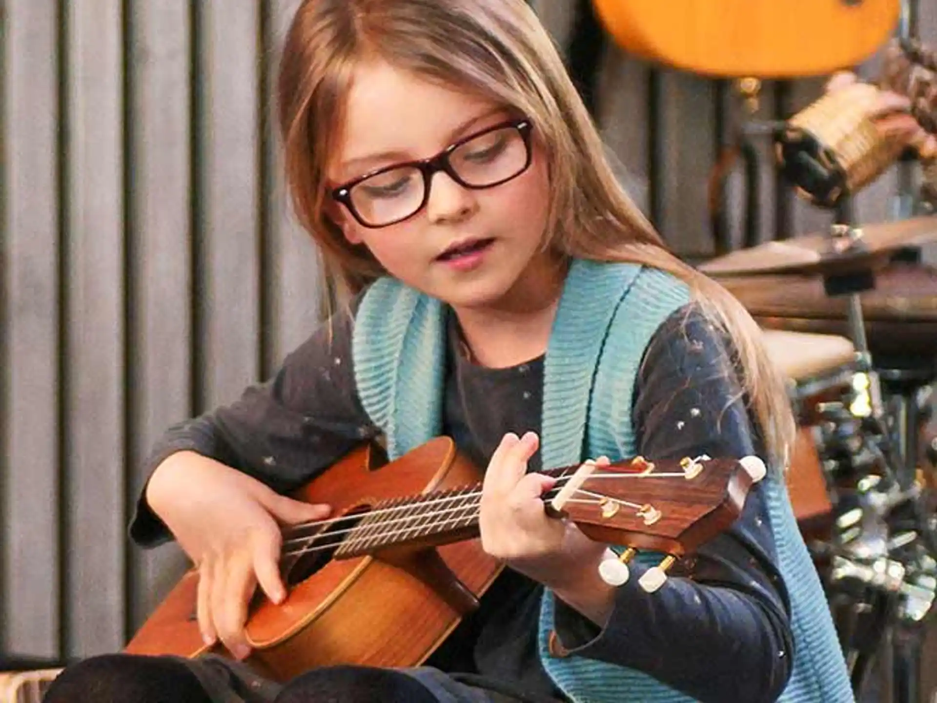 a woman playing a guitar