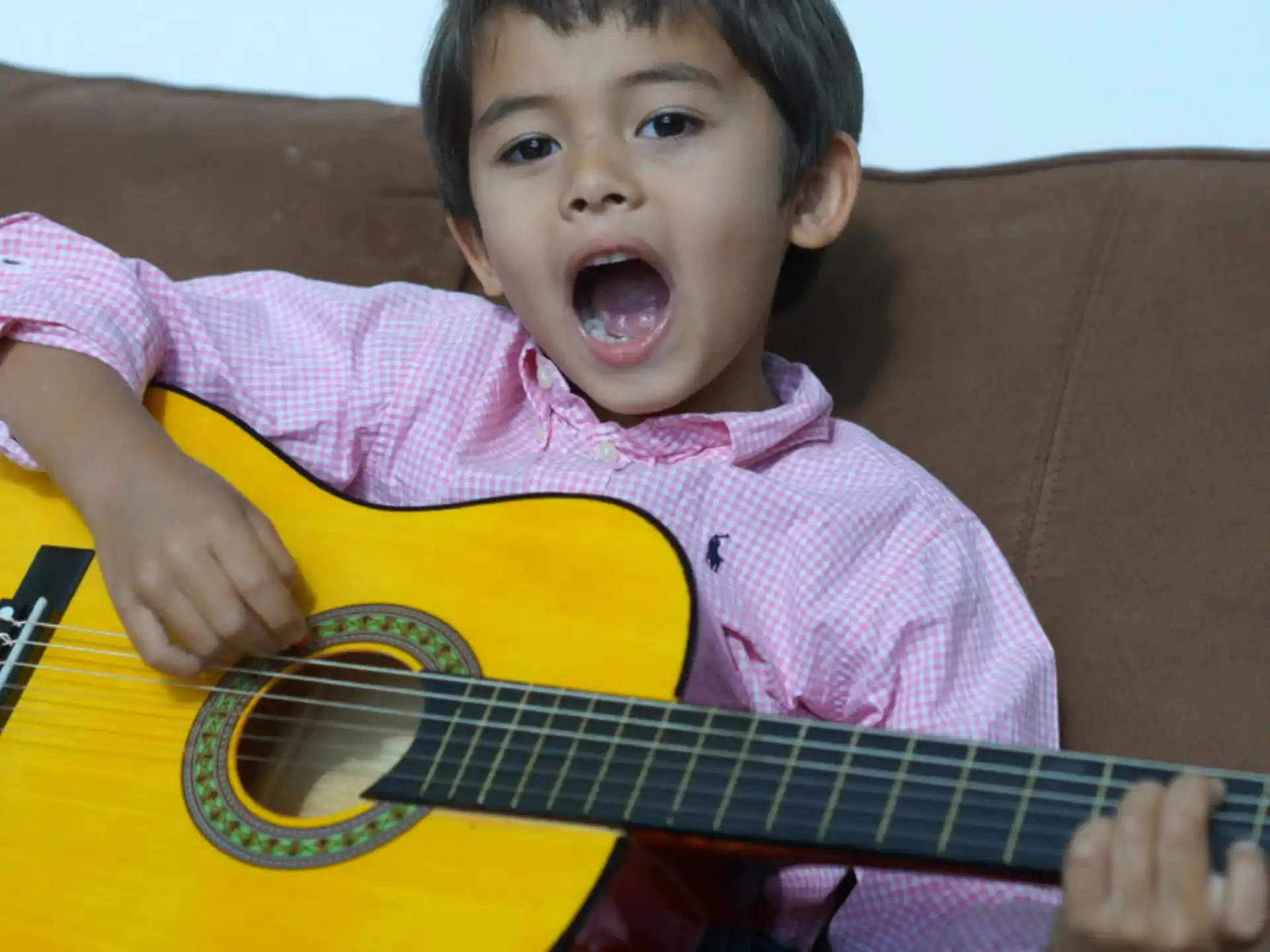 a child playing with a guitar