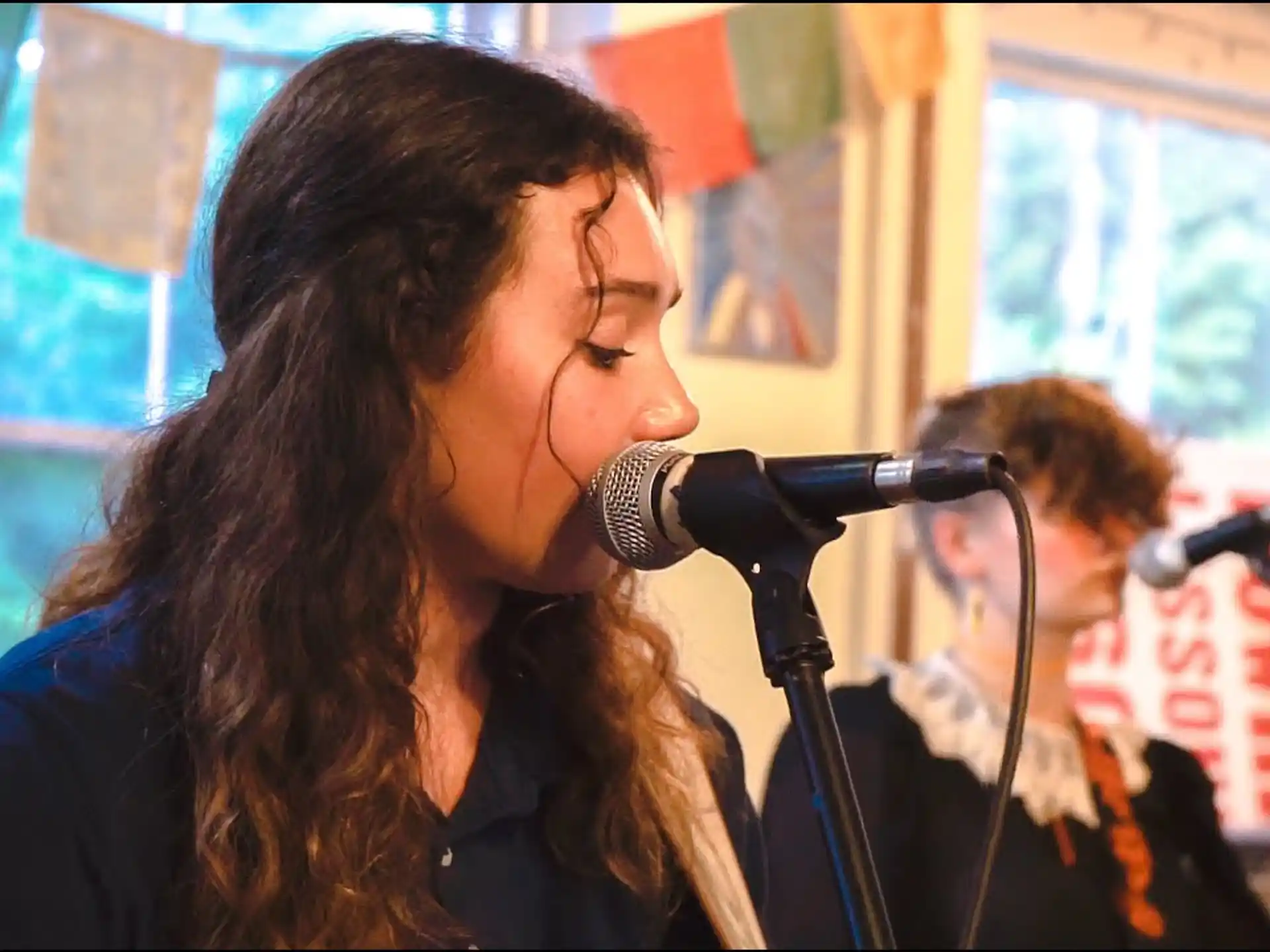 a woman singing into a microphone