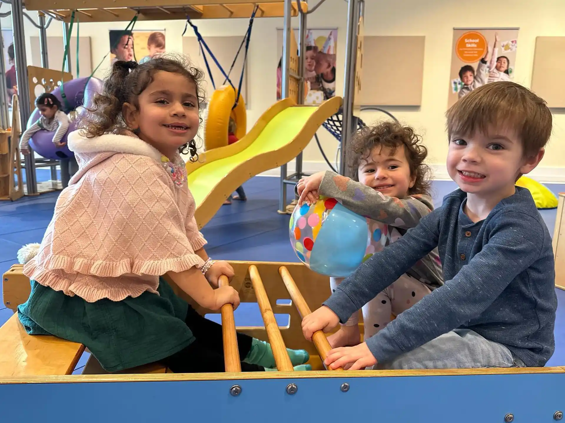 a group of children playing on a playground toy