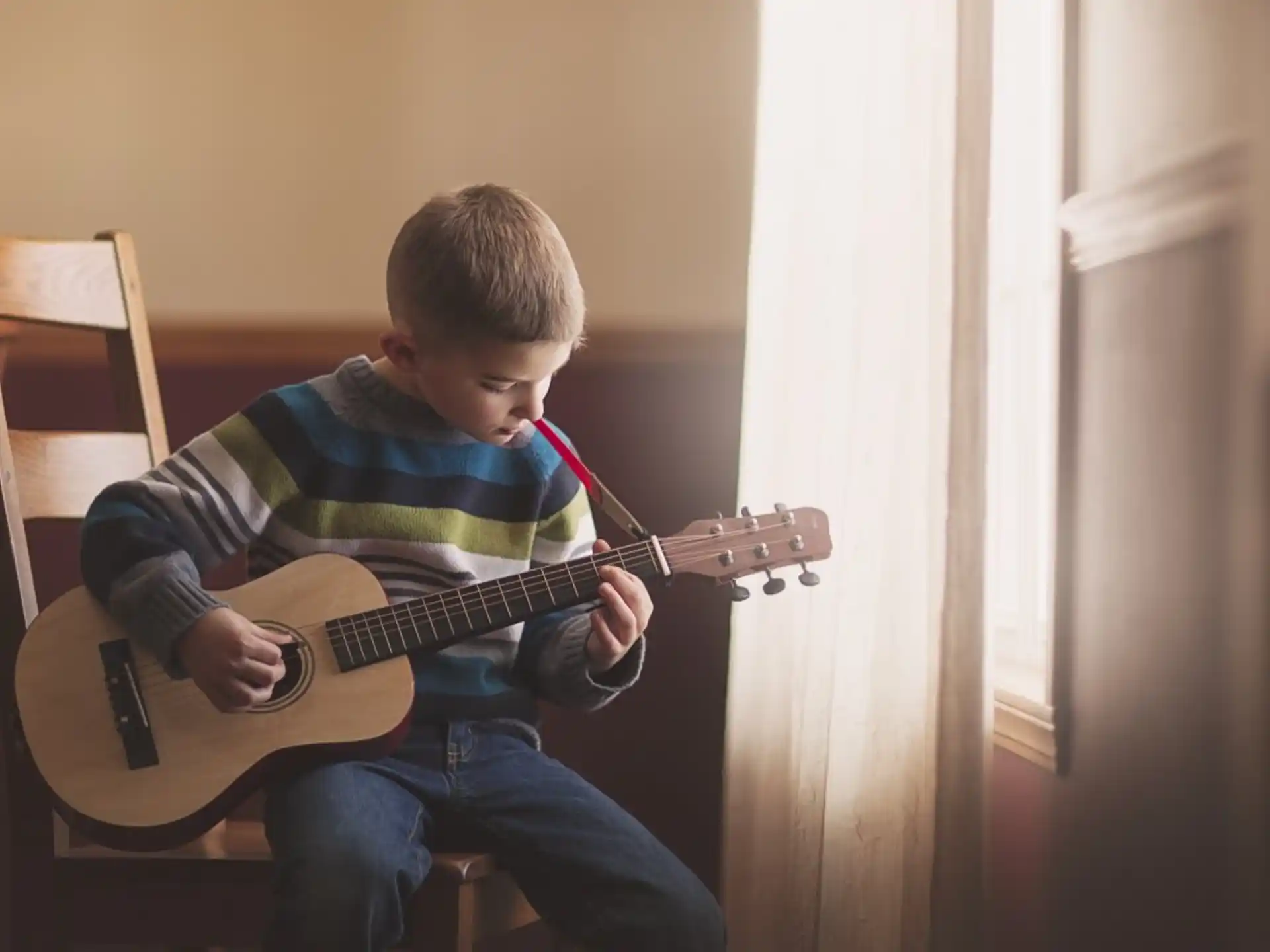 a boy playing a guitar
