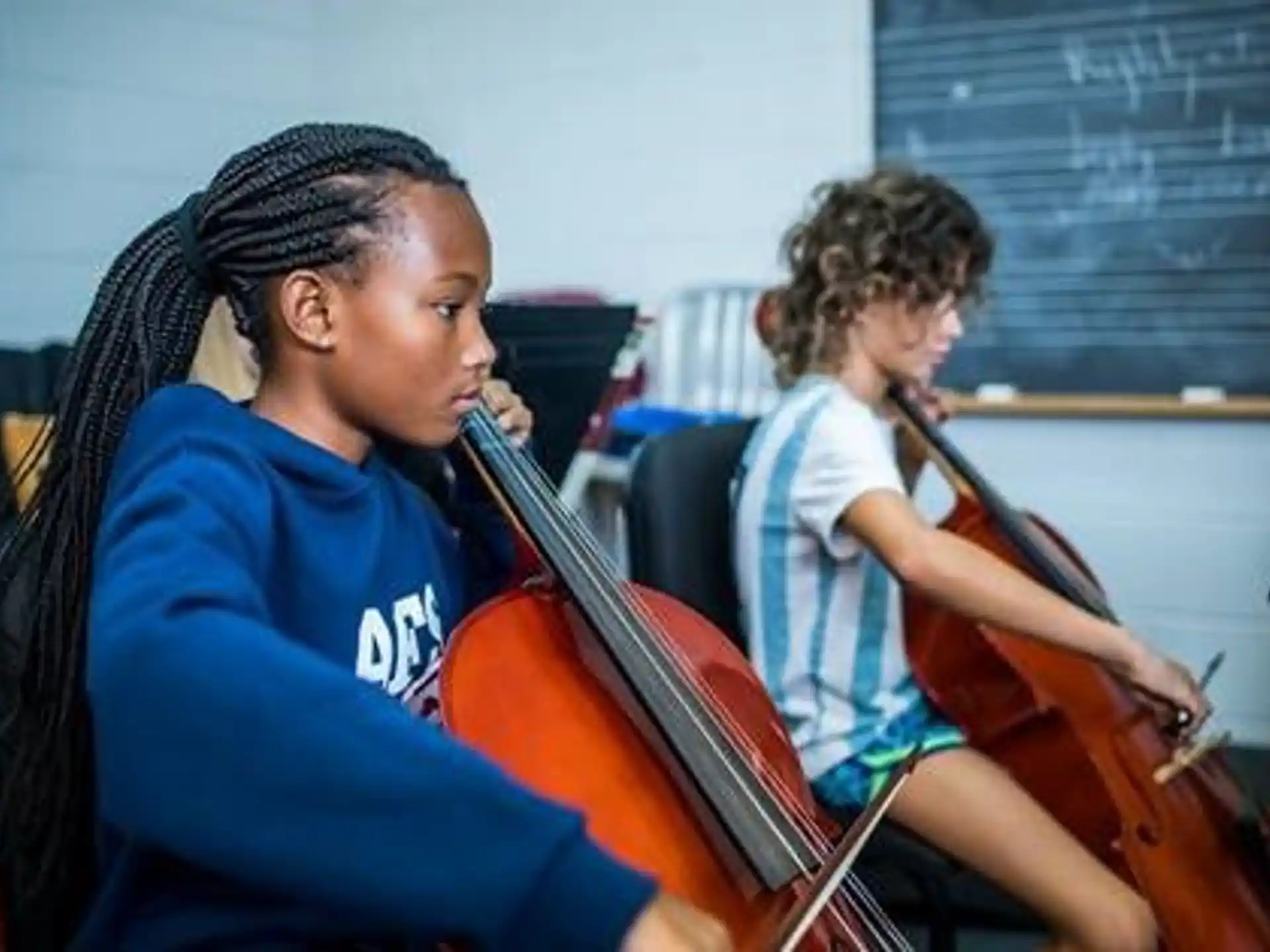 a young girl playing a violin