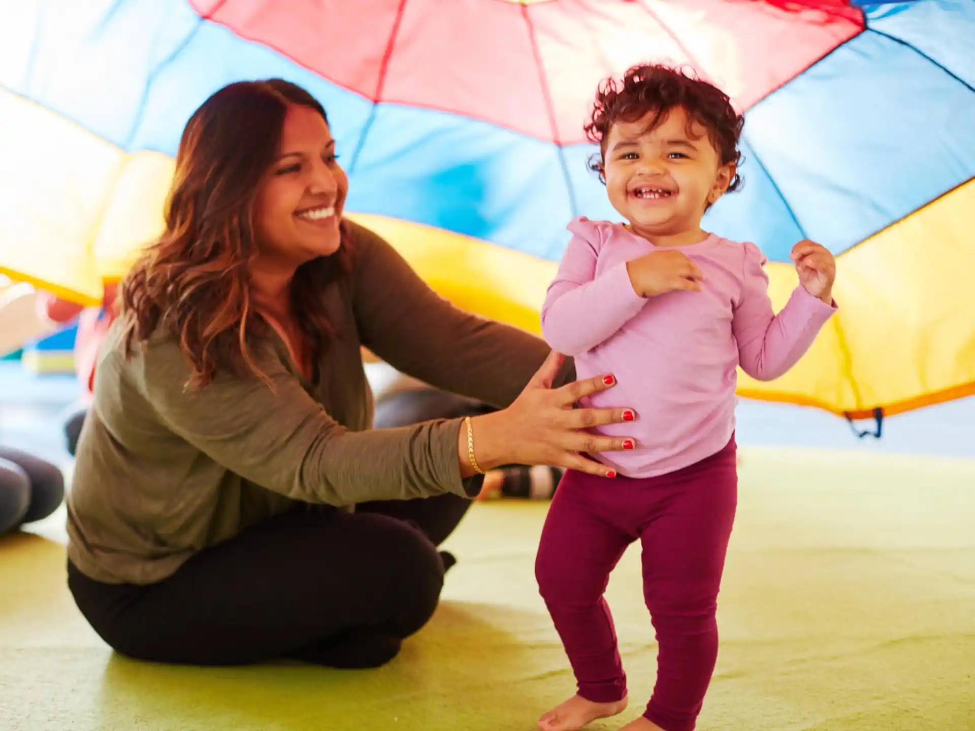 a person and a child under an umbrella