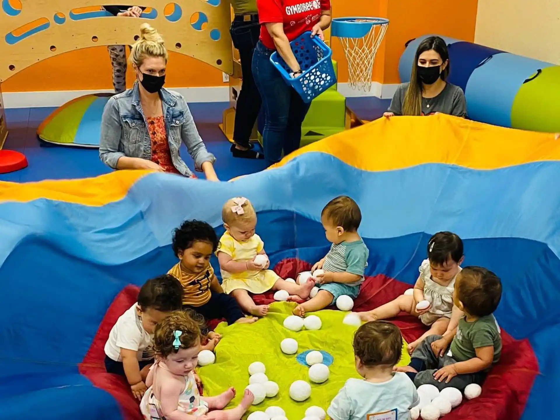 a group of people sitting on a colorful slide