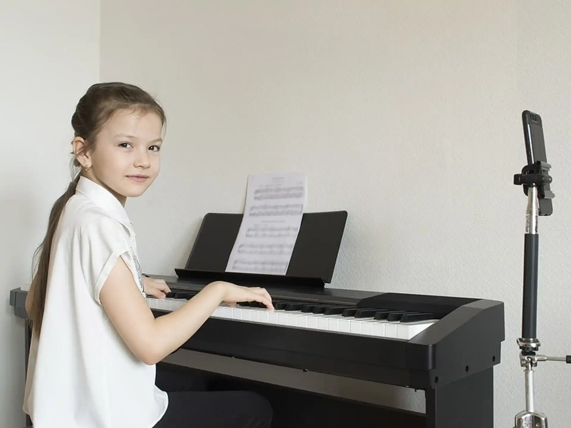 a girl playing a piano
