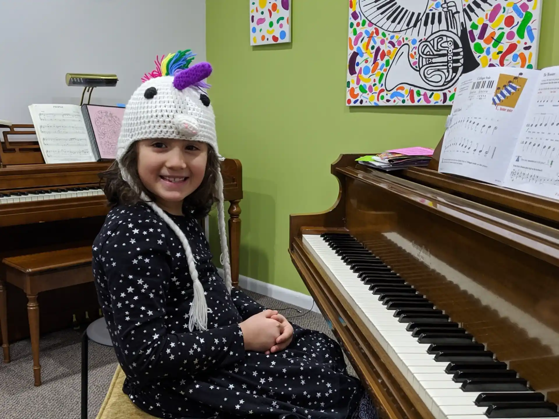 a girl sitting at a piano