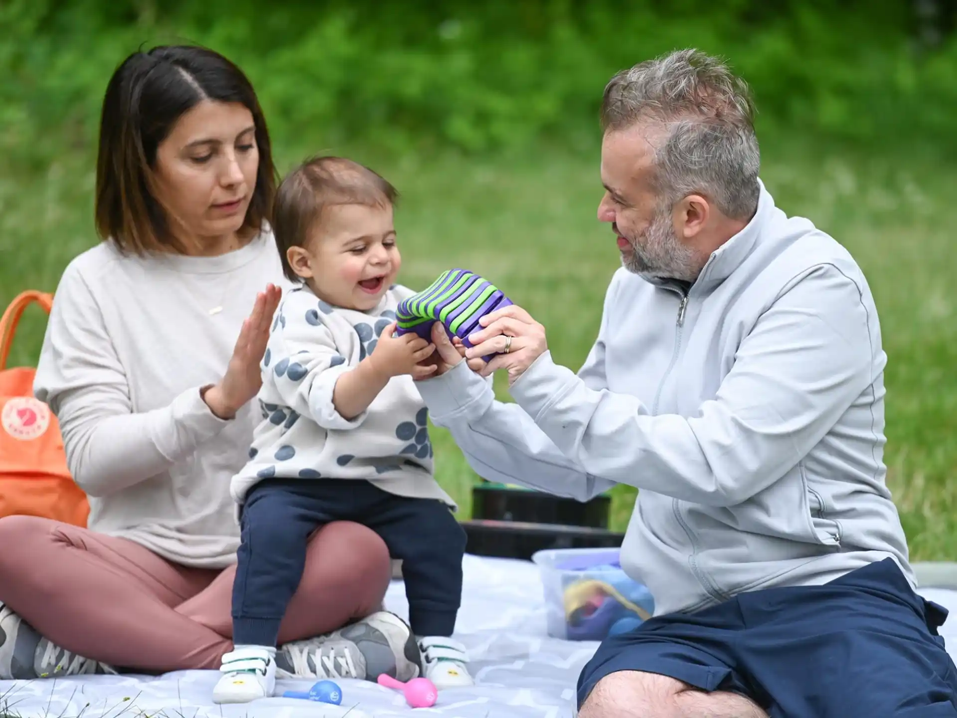 a man and woman holding a baby