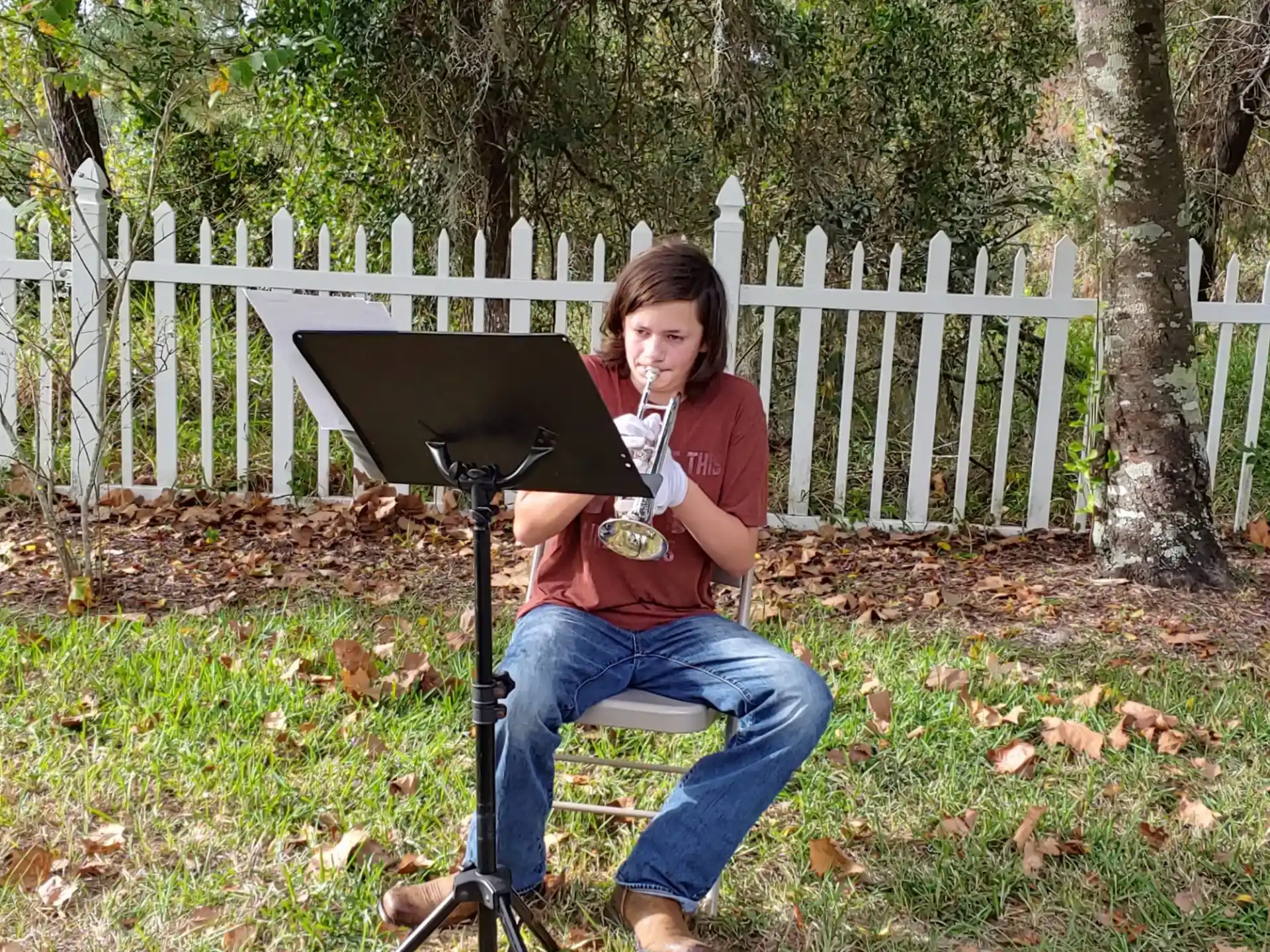 a person sitting outside with a laptop