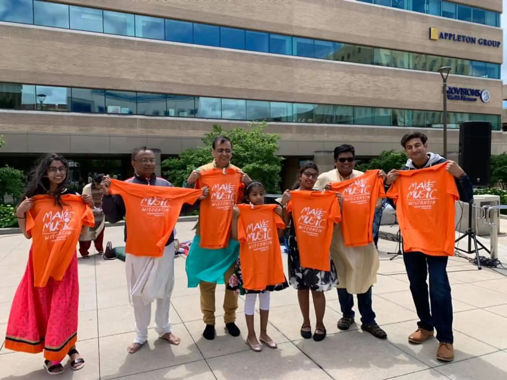 a group of people wearing orange shirts