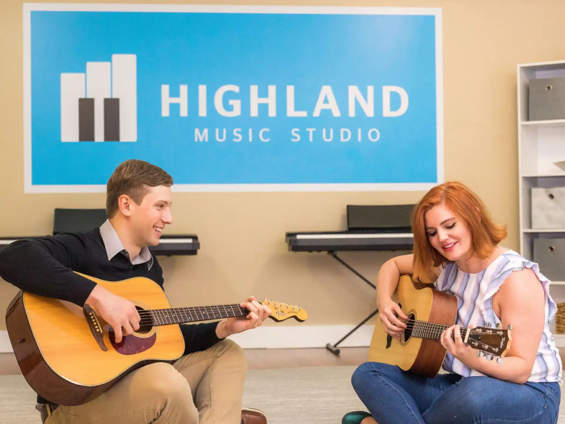 a man and a woman playing guitar