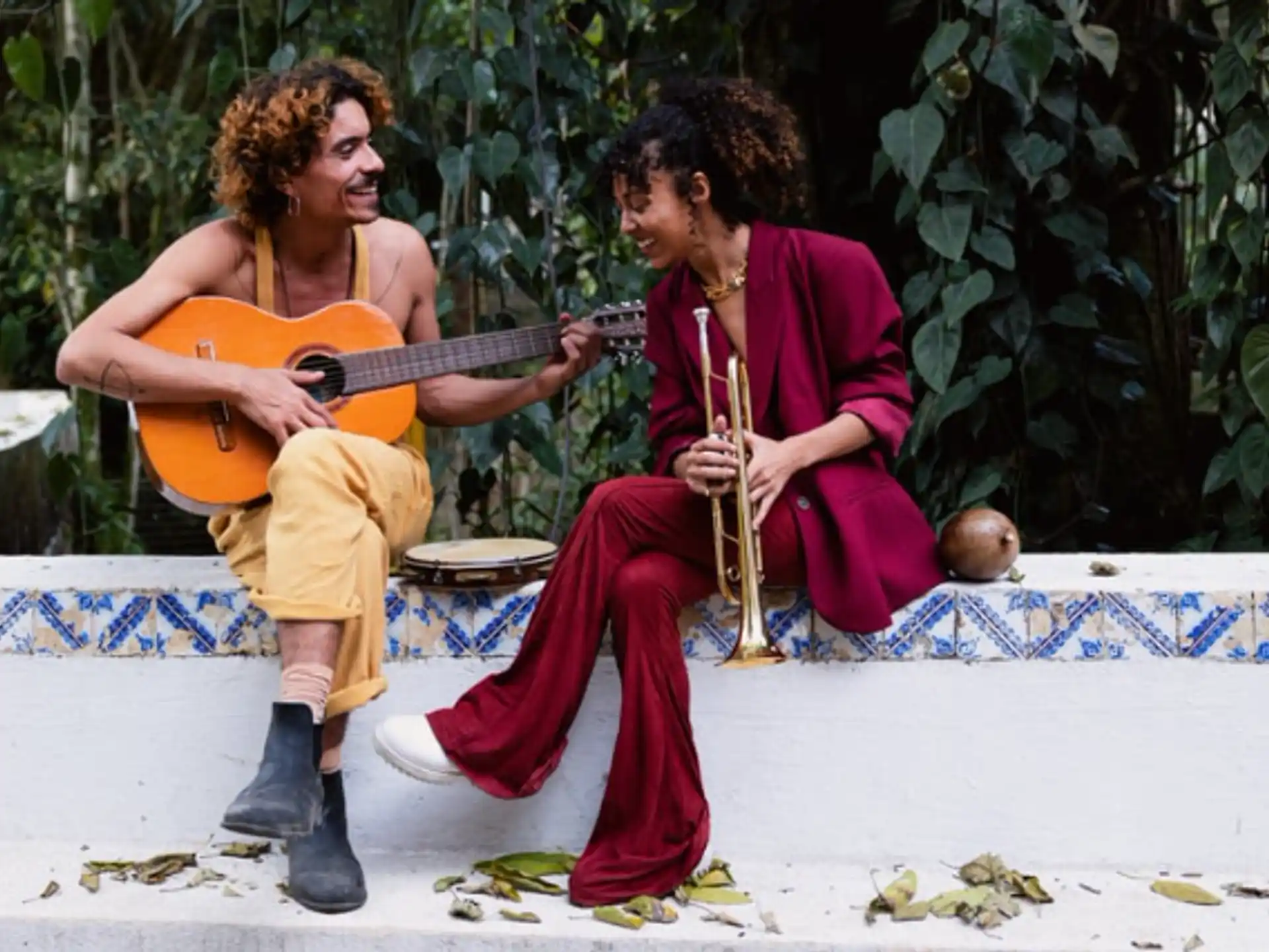 a man and woman playing guitar