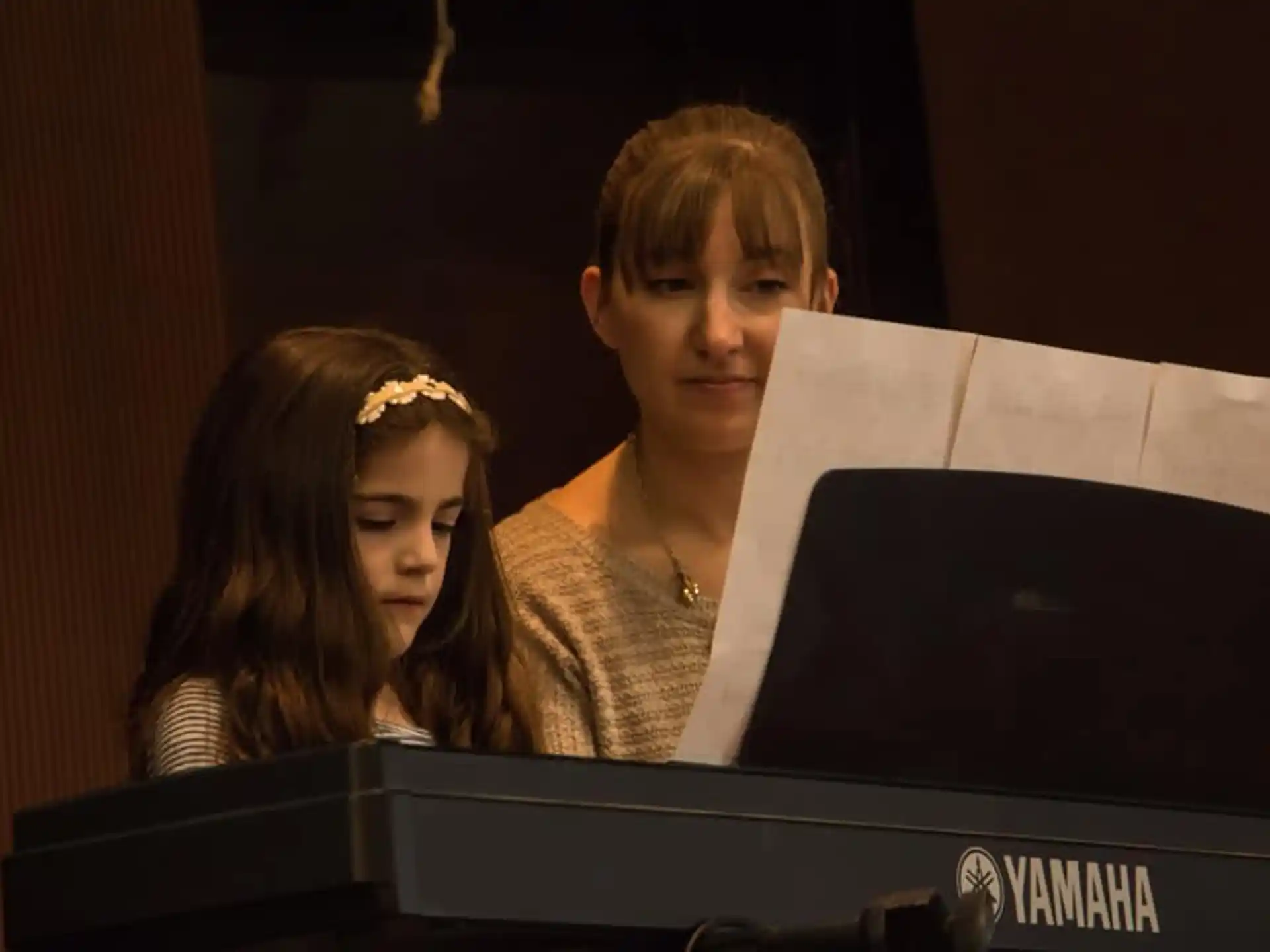 a person and a boy looking at a computer screen