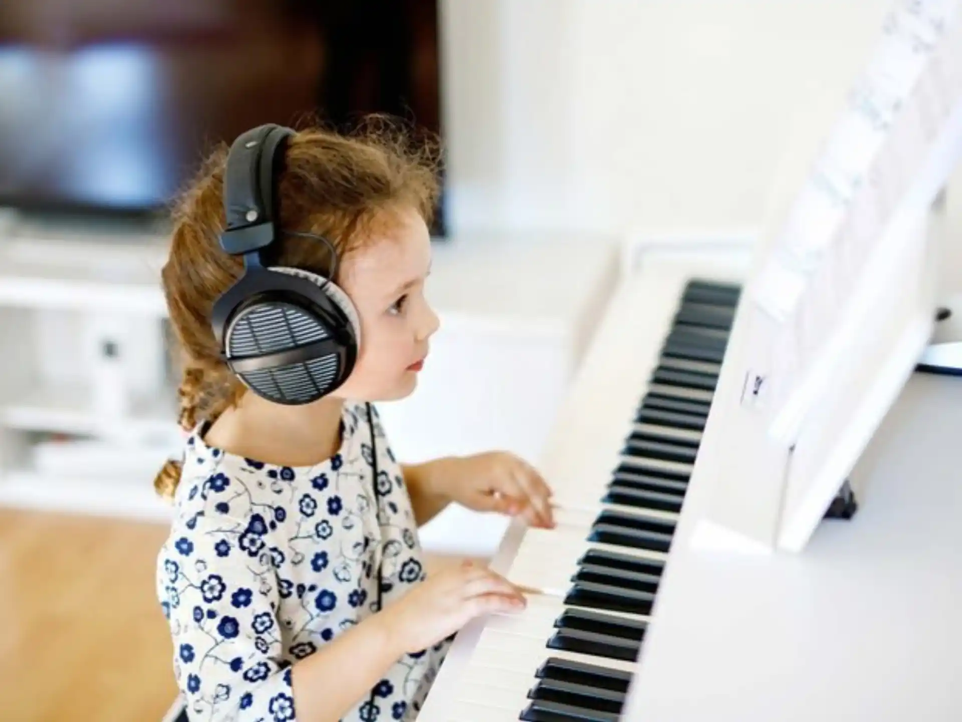 a young girl playing a piano