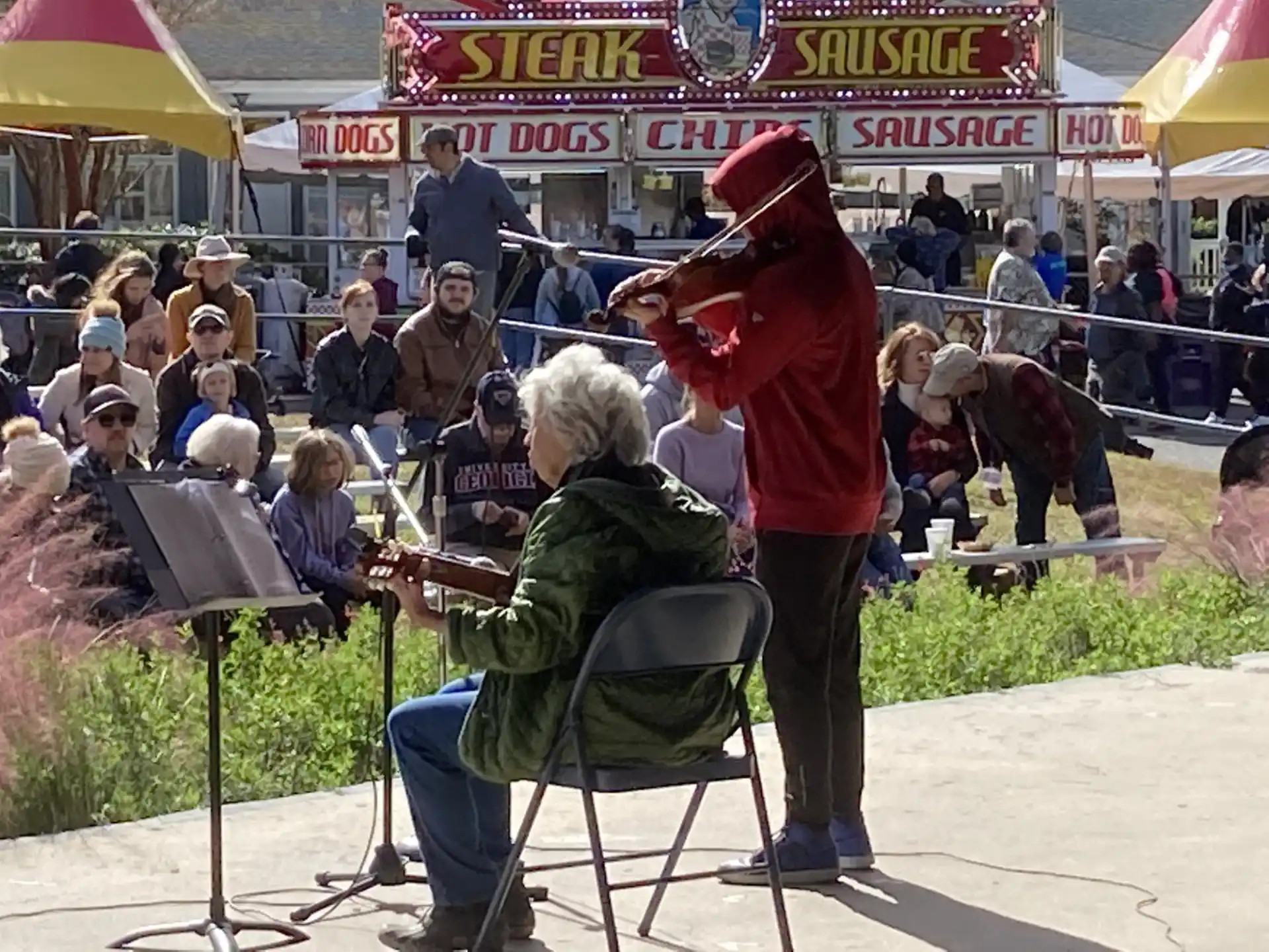 a person playing a piano in front of a crowd of people
