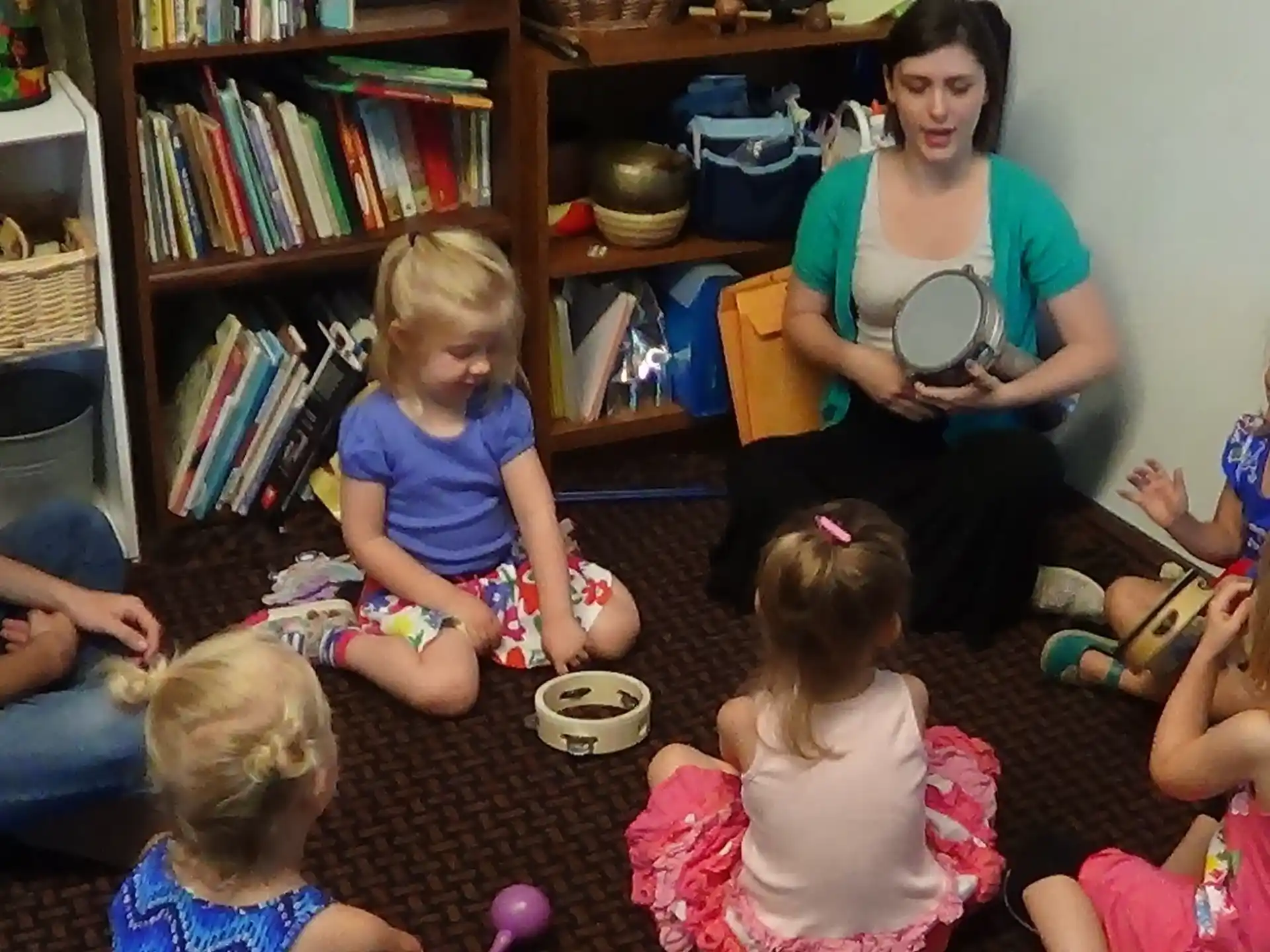 a person reading to a group of children