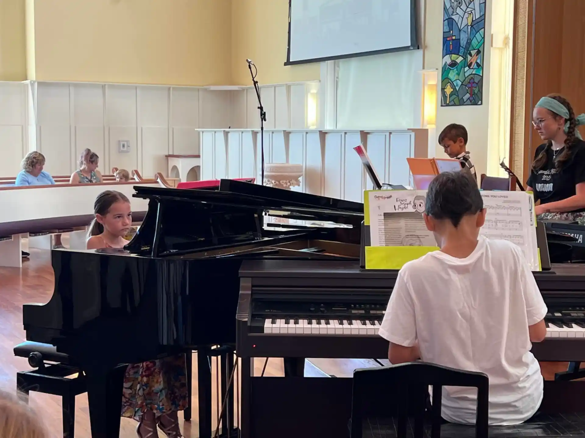 a group of people playing piano