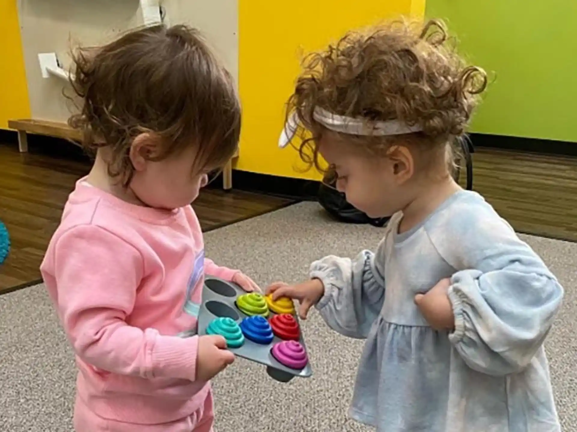 a couple of children playing with toys