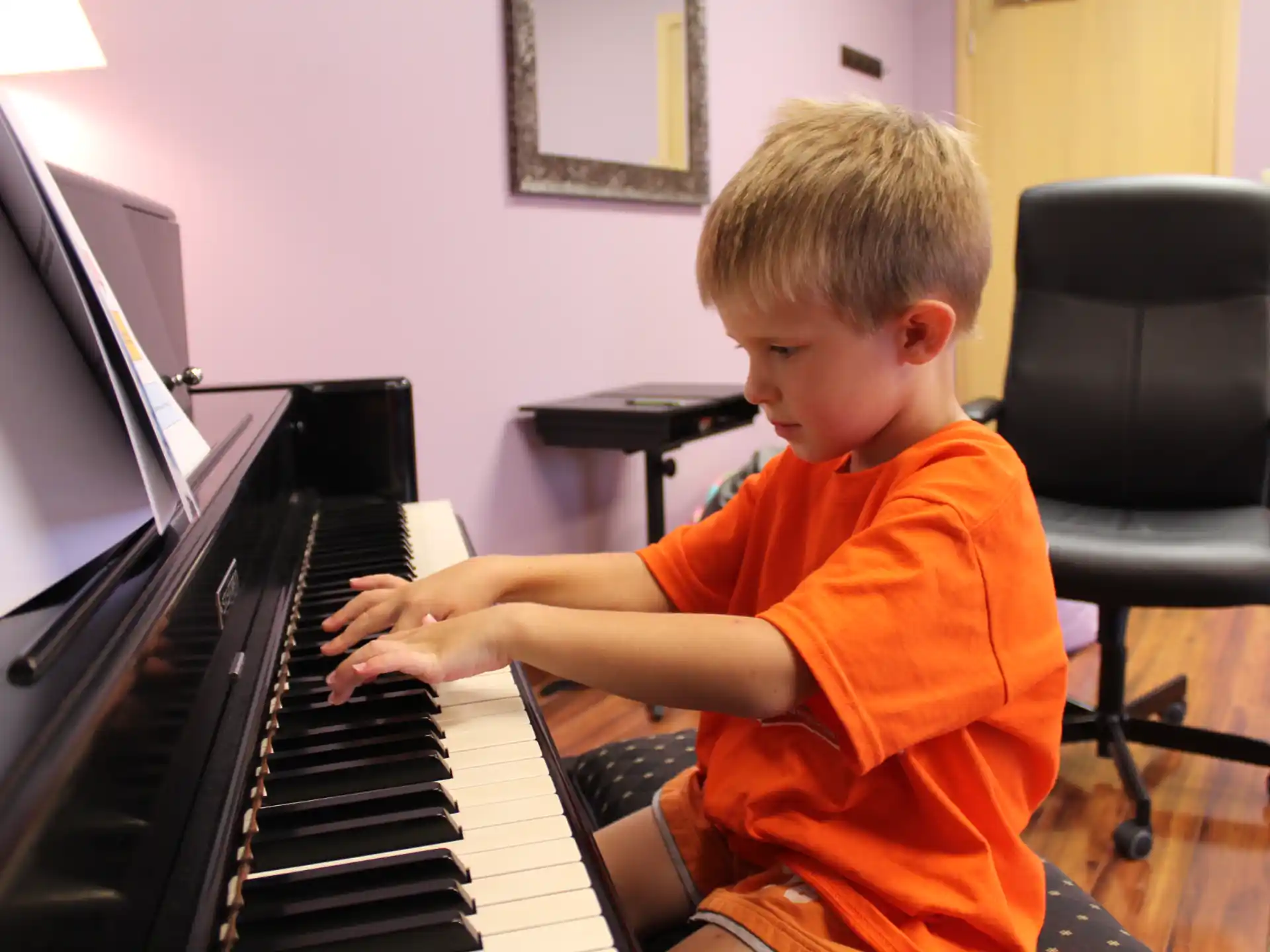 a boy playing a piano
