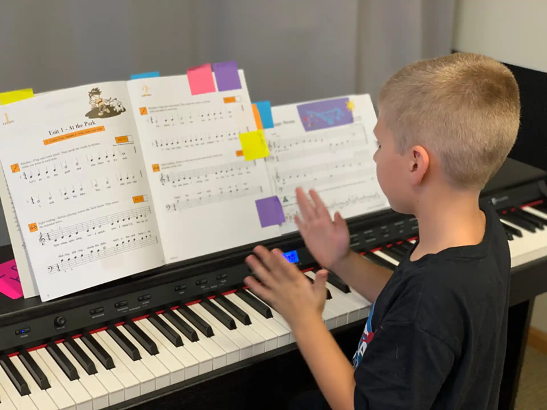 a boy playing a piano
