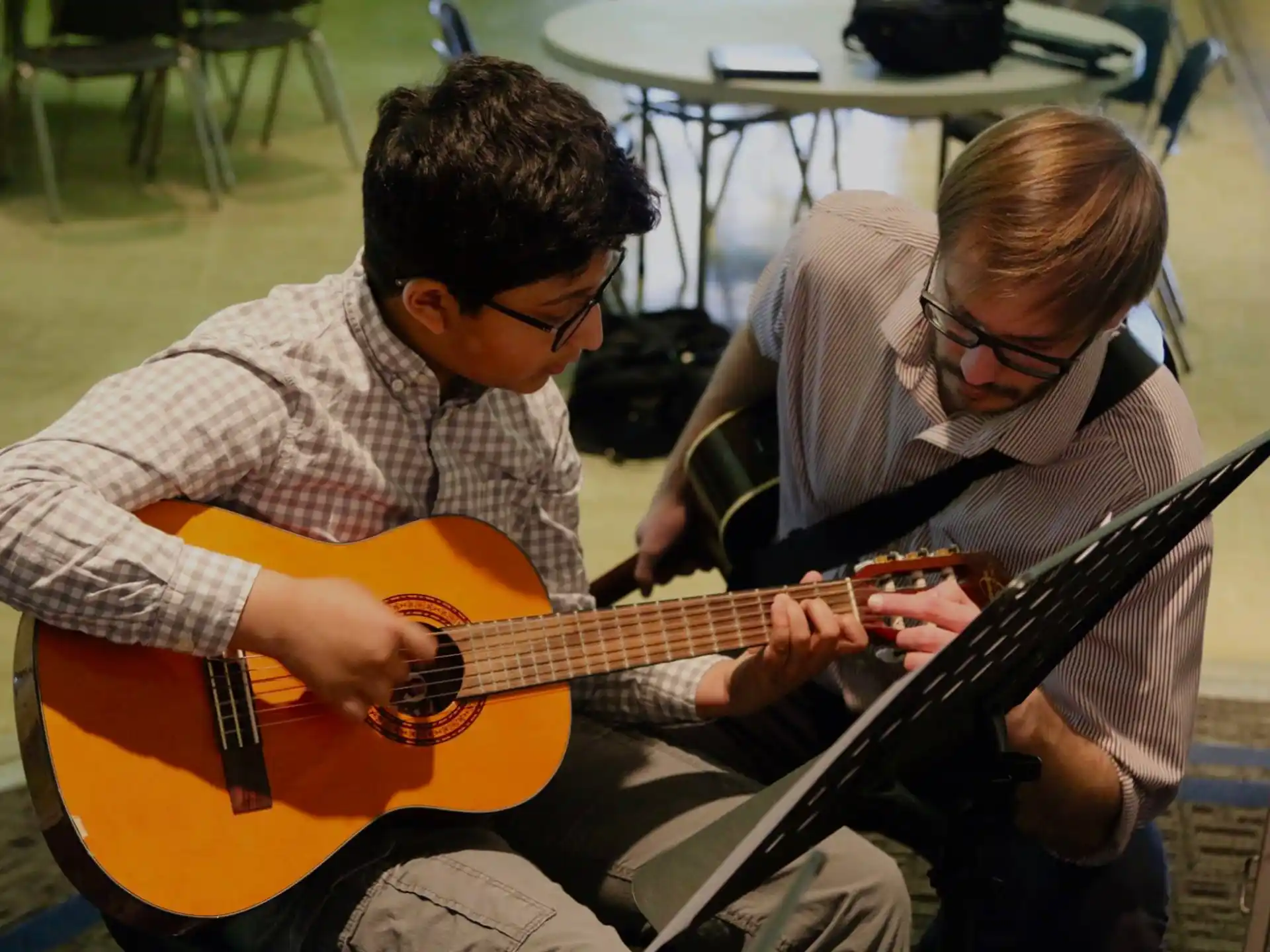 a couple of men playing guitars