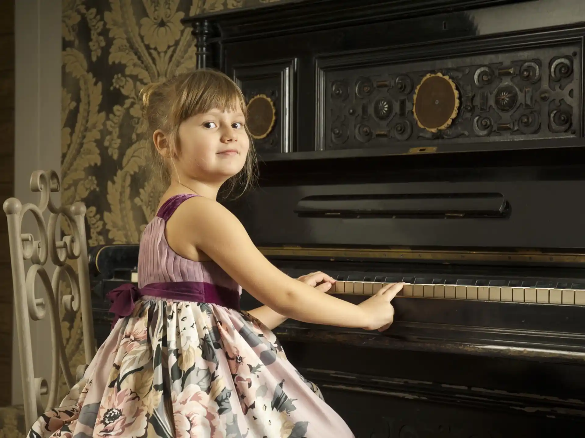 a girl playing a piano