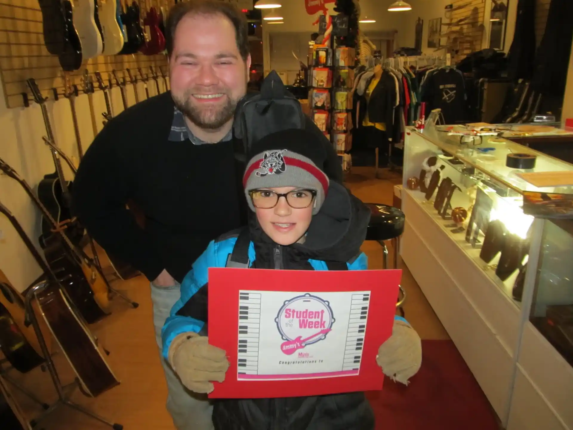 a man and a boy holding a sign in a store