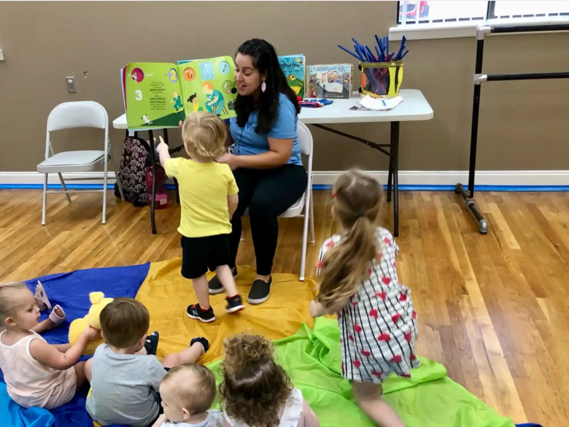 a person and several children sitting on the floor
